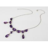 A continental amethyst necklace, designed as a row of seven graduated oval mixed cut amethysts,