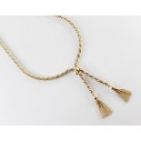 A continental tassel necklace, the white and yellow metal rope twist chain terminating in two tassel