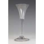 A trumpet wine or cordial glass, the flared bowl on plain stem terminating in wide conical folded