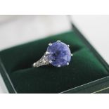 A sapphire and diamond ring, the central mixed cut cornflower blue sapphire measuring 10.61mm L x
