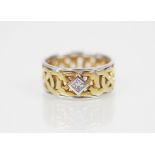 An 18ct gold diamond set Celtic style ring, the central princess cut diamond measuring 2.5mm x 2.