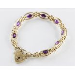 A yellow metal amethyst set bracelet, comprising eight faceted oval amethysts, each measuring 7mm