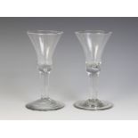 A bell bowl wine glass, the bowl with teared base on plain stem terminating in a wide conical