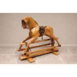 A Relko laminated wooden rocking horse, late 20th century, with a natural wooden finish, applied