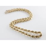 A long gold coloured rope twist chain, lobster claw and loop fastening, jump ring with 9ct gold