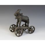 A Indian painted iron child's pull-along toy, early 20th century, modelled as a scared cow upon a