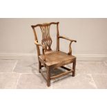 A country Chippendale style elm elbow chair, late 18th/early 19th century, the cupids bow top rail