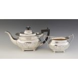 An Edwardian silver teapot, Martin, Hall & Co, Chester 1907, of compressed form with half-reeded