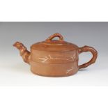 A Chinese Yixing teapot and cover, 19th/20th century, the buff coloured exterior incised with bamboo