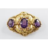 A Victorian amethyst set cannetille work brooch, comprising three mixed cut oval amethysts,