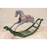 An early 20th century spotted grey wooden rocking horse, circa 1900, later re painted, applied
