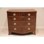 An early 19th century mahogany bow front chest of drawers, formed of two short of three long