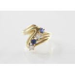 A diamond and sapphire set 18ct gold ring, comprising two mixed cut sapphires and two brilliant