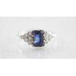 An Art Deco diamond and sapphire ring, the rectangular step cut sapphire measuring 7mm x 4mm, claw