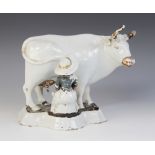 An unusual 18th/19th century tin glazed Delft pottery study of a seated milkmaid and her cow,