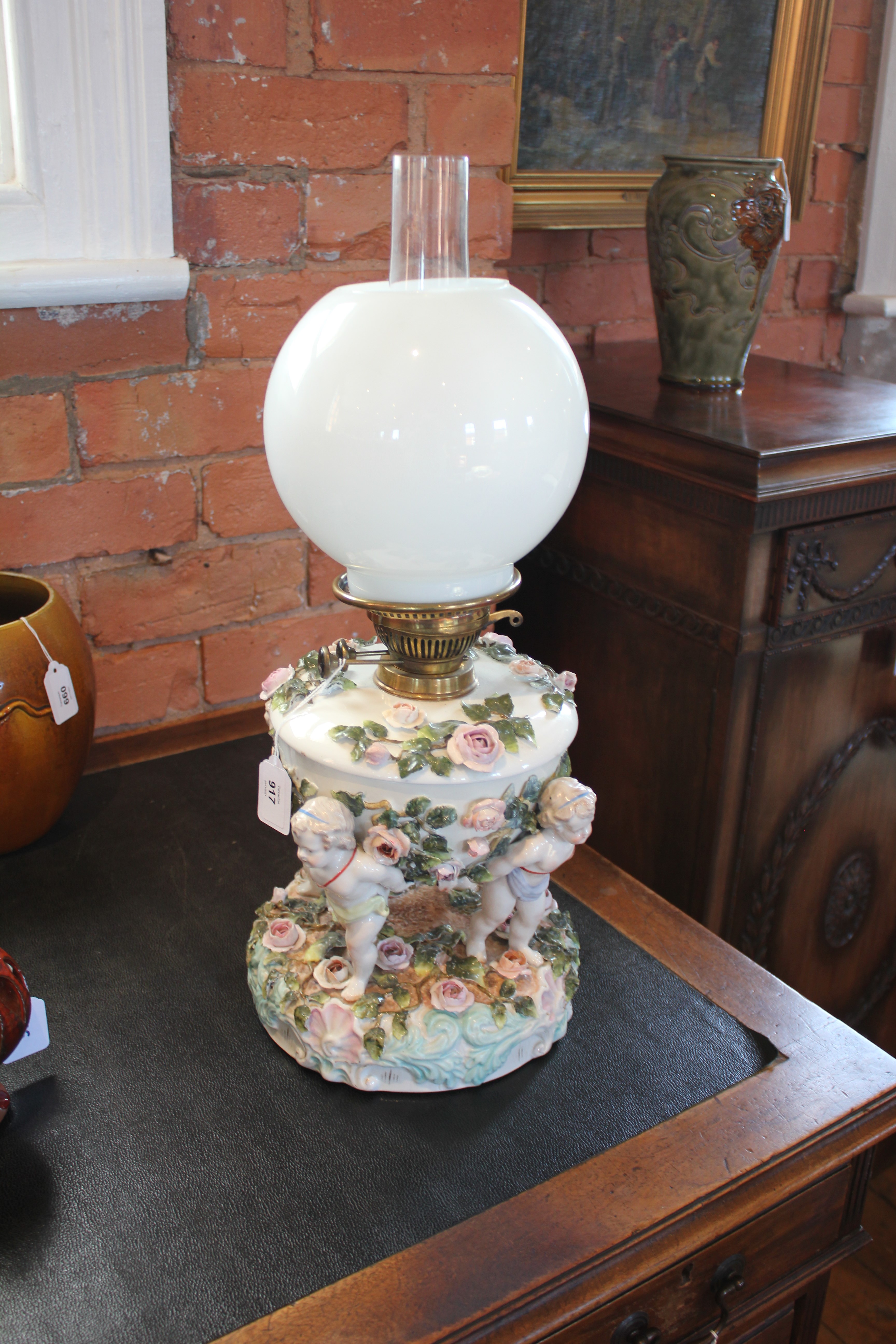 An German florally encrusted porcelain oil lamp, 19th century, modelled with four putti supporting - Image 4 of 8