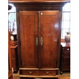 A large French oak armoire, 19th century, the moulded cornice over two cleated doors and two