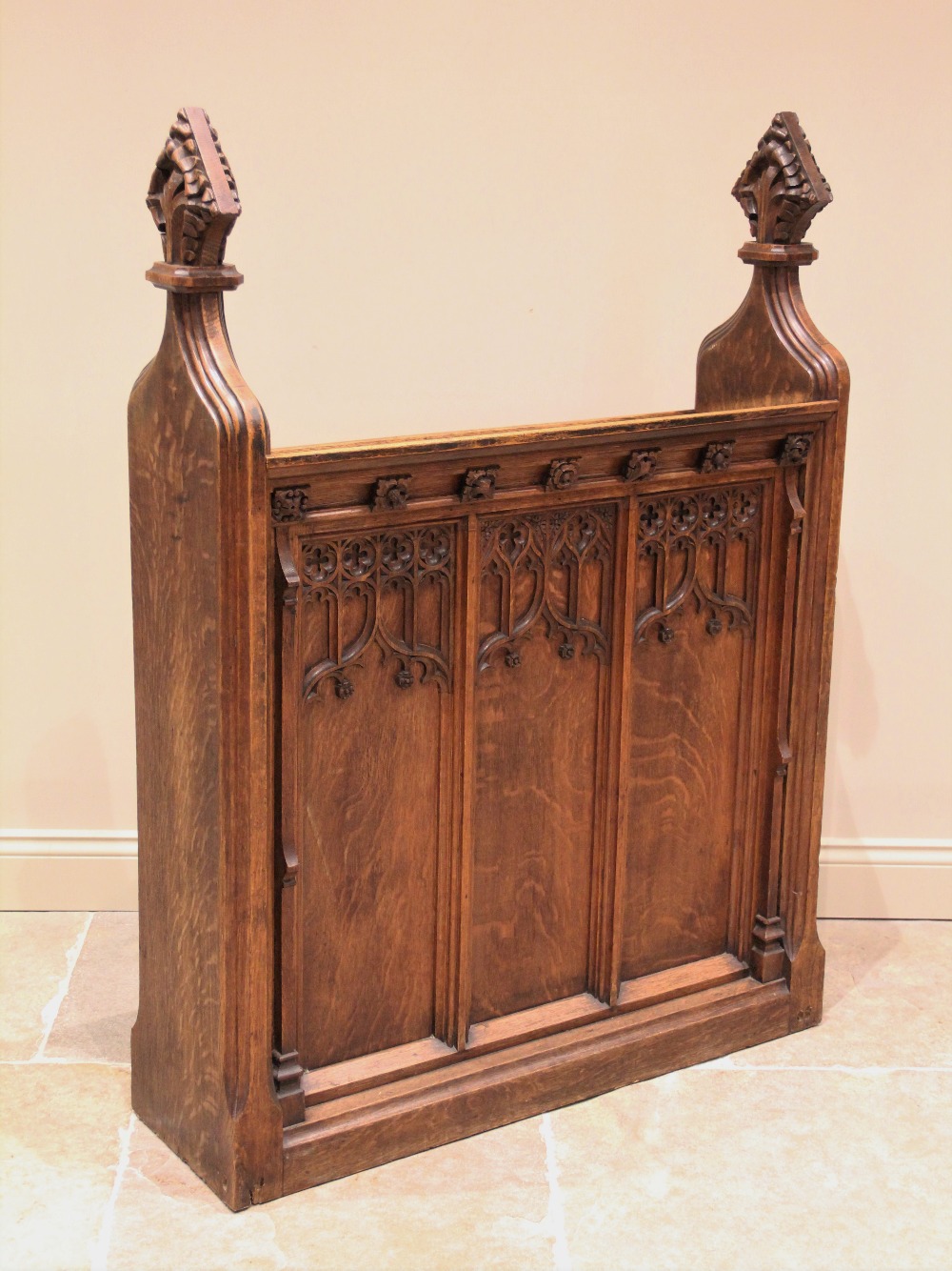 A Victorian oak church lectern, the sloping book rest supported on a pair of gothic ogee uprights