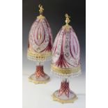 A pair of Bohemian cranberry flash cut crystal table lamps, mid 20th century, the bell shaped shades