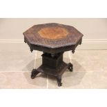 A profusely carved Anglo-Indian teak pedestal occasional table, late 19th century, the octagonal top