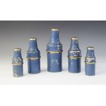 Five early 20th century chemist?s drug bottles, each glass bottle contained within a blue painted