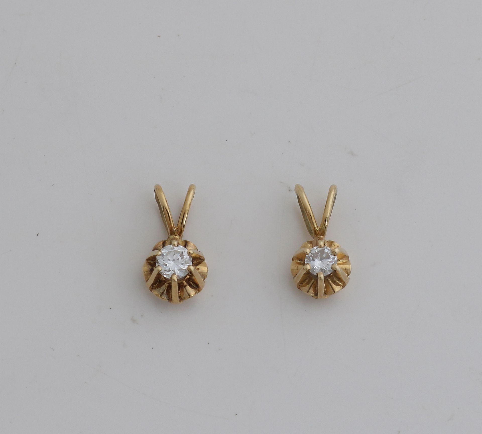 2 Gold pendants with diamonds.