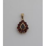 Gold pendant with garnet