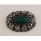 Silver brooch with green stone