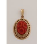 Gold pendant with carved coral