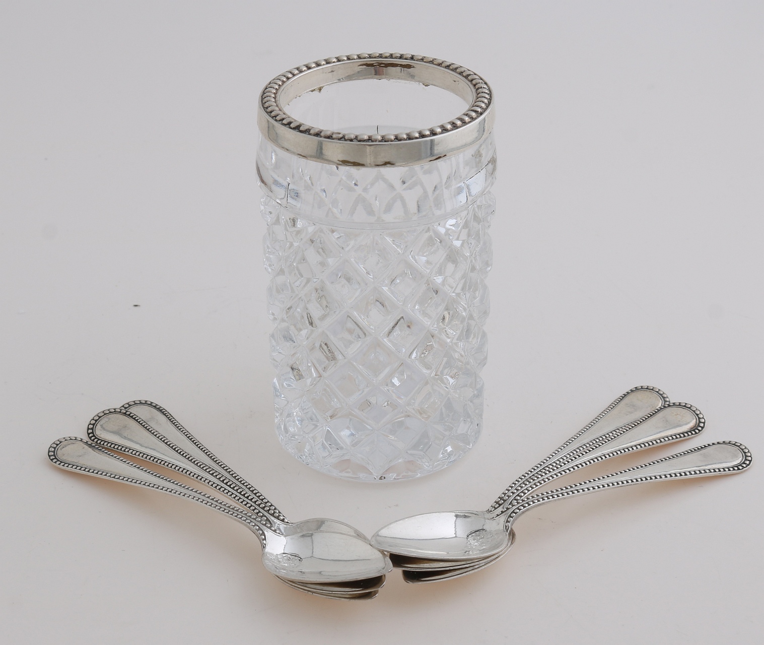 Spoon vase with silver spoons