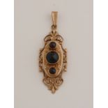 Gold pendant with garnet