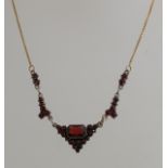 Gold necklace with garnet pendant