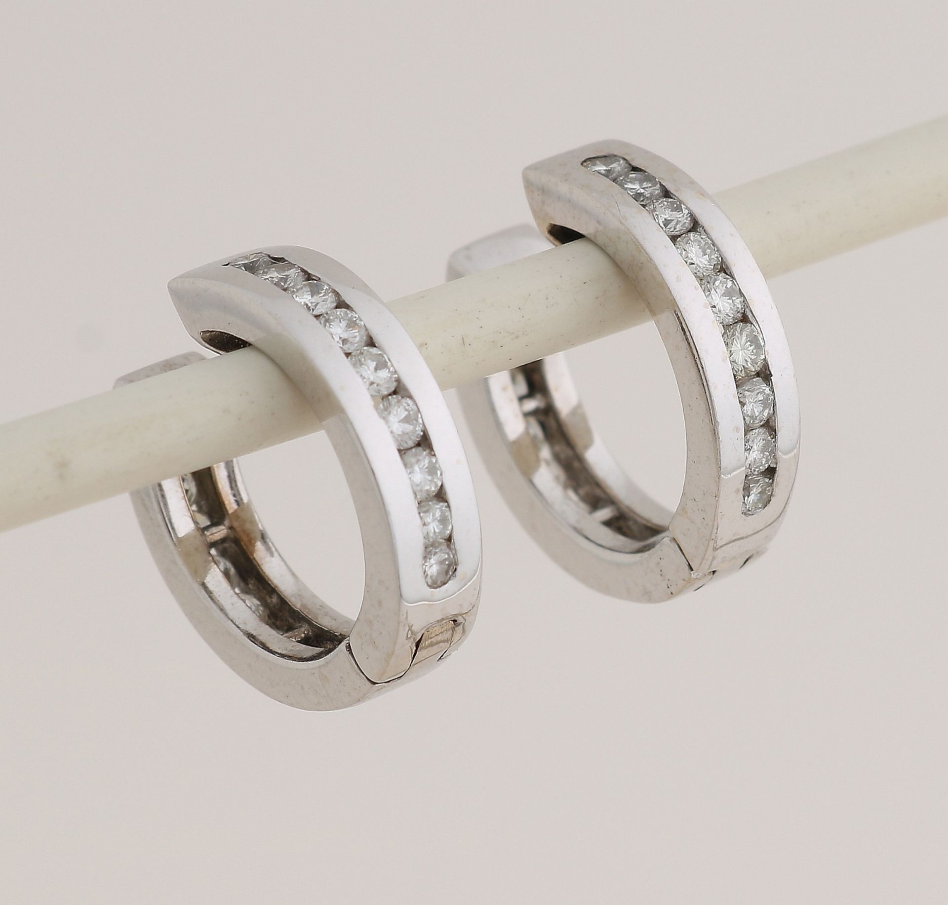 White gold creoles with diamonds.