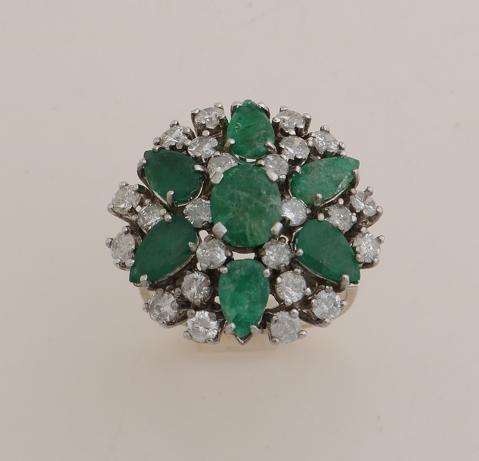 White gold ring with diamond and emerald