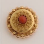 Gold brooch with coral.