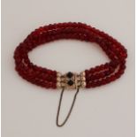 Bracelet with garnet and gold clasp