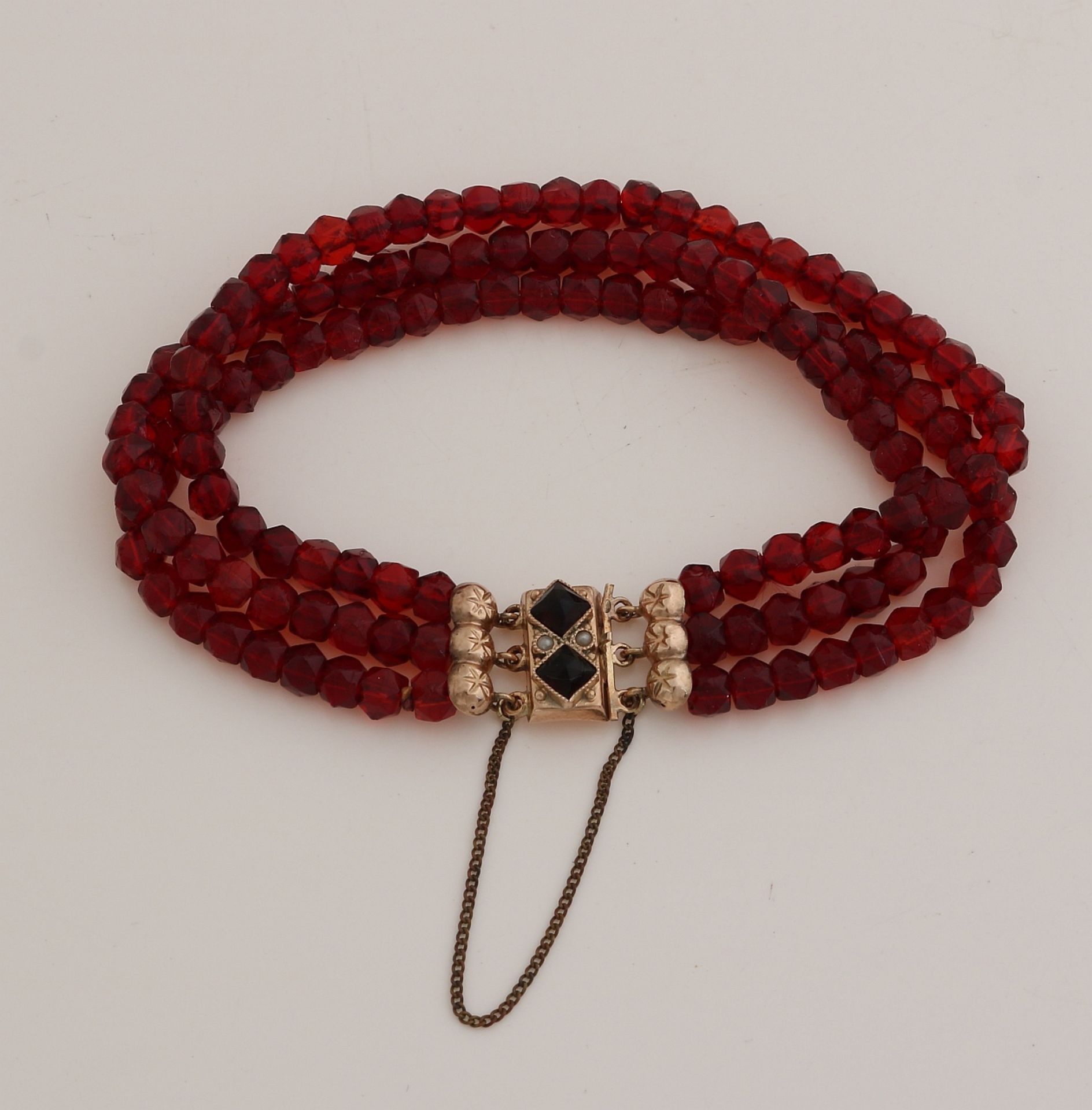 Bracelet with garnet and gold clasp