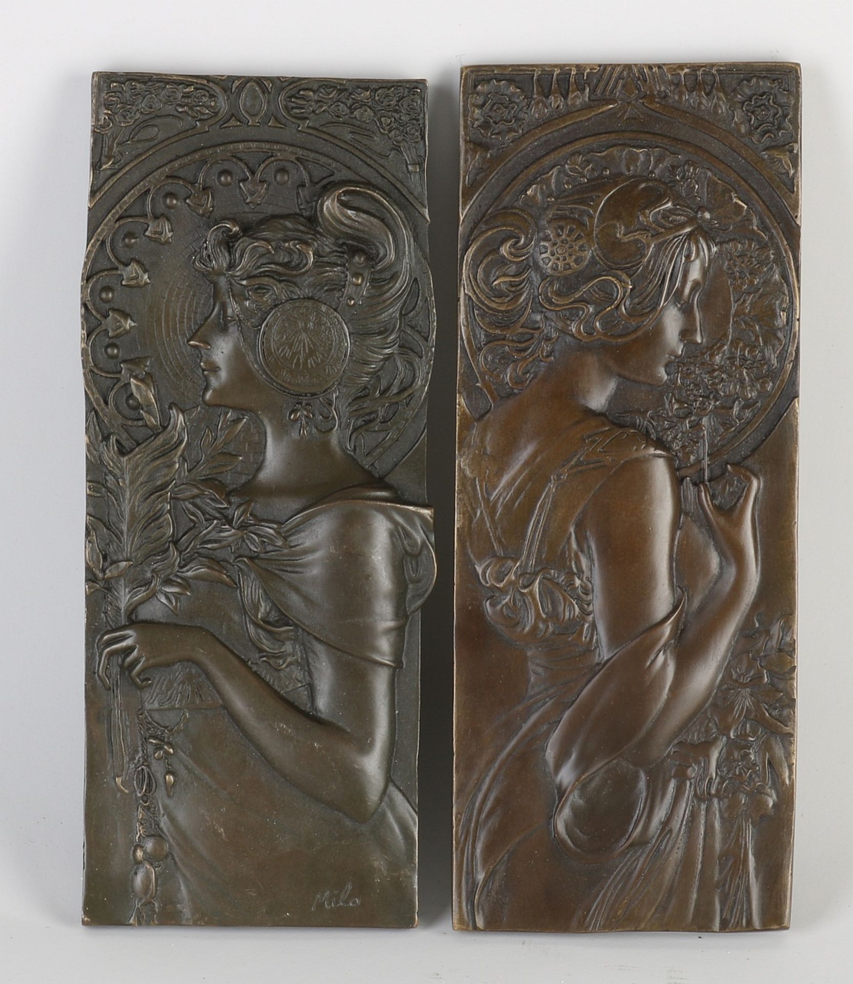 Two bronze wall plaques