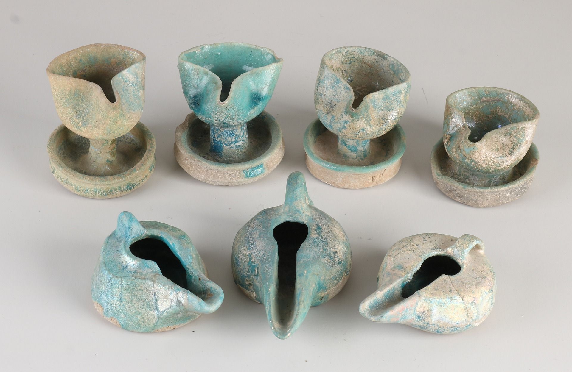 Seven antique Nishapur oil lamps