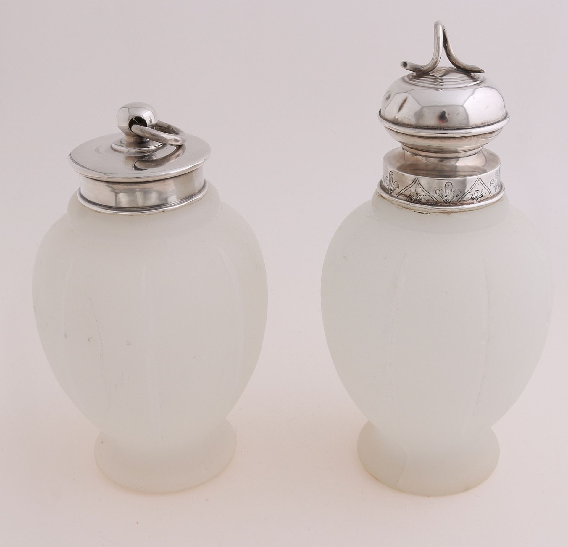 Two tea canisters with silver caps