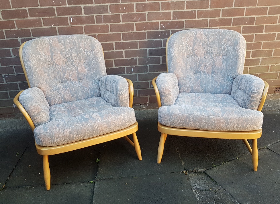 A pair of Ercol Beech and Elm Jubilee Armchairs with fitted cushions