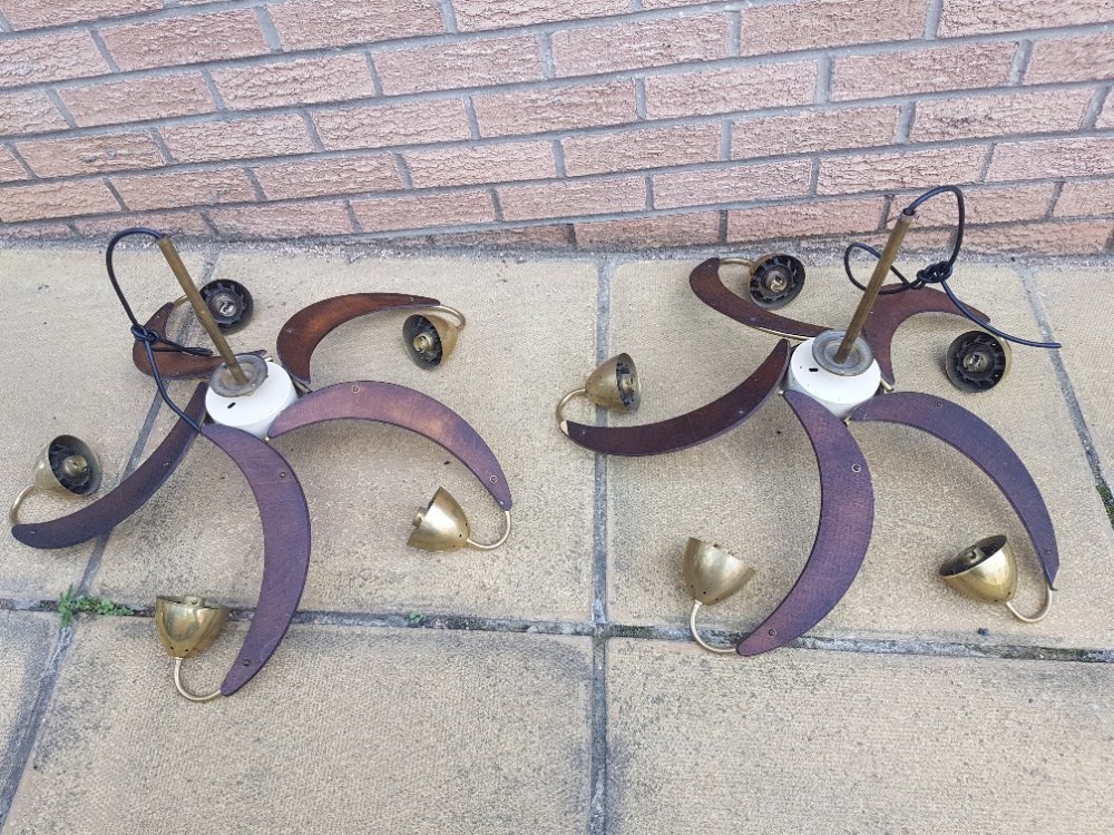 Pair of vintage teak veneered and brass five branch propeller light fittings