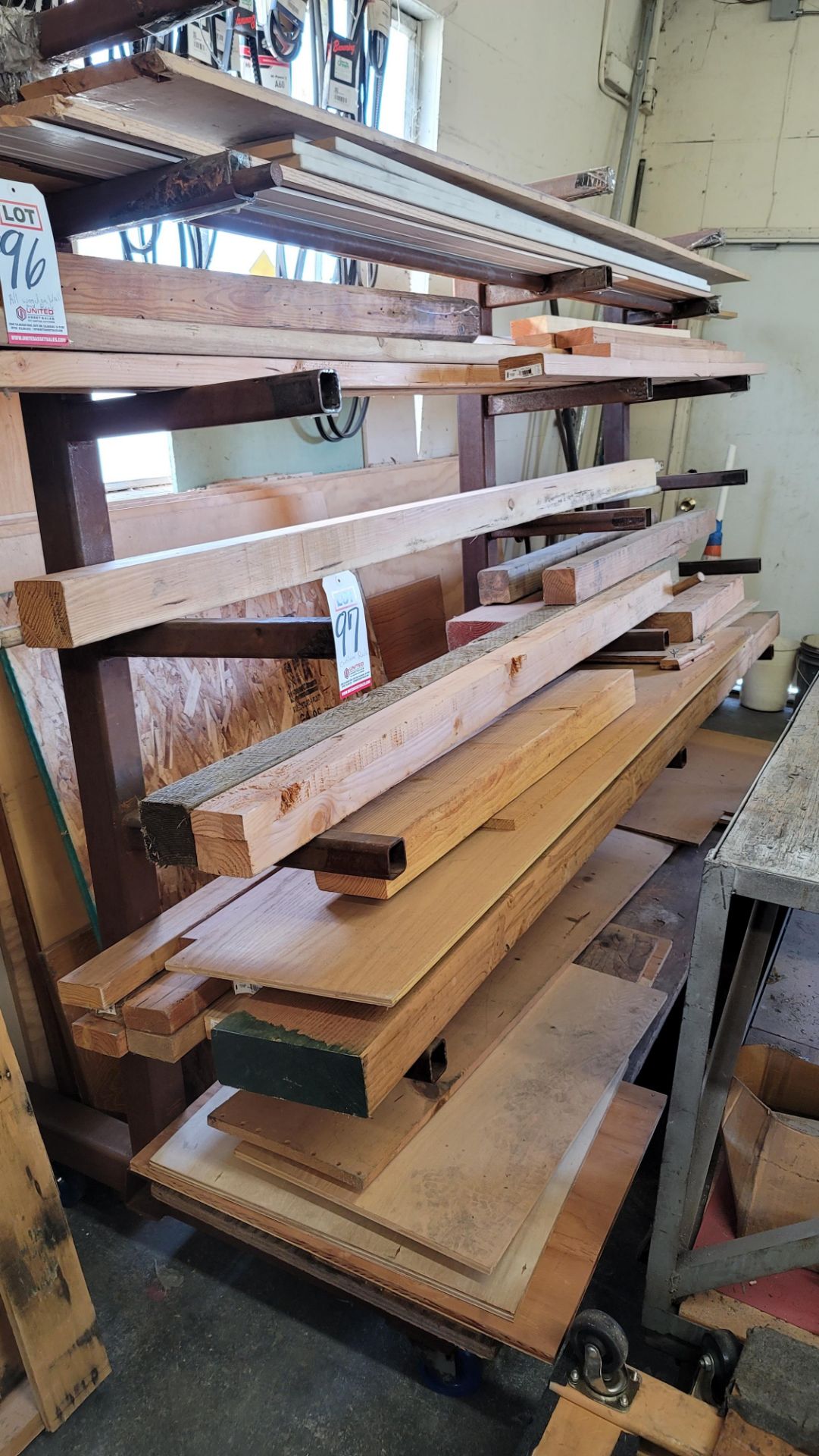 LOT - ALL LUMBER ON RACK AND PLYWOOD BEHIND RACK, RACK NOT INCLUDED