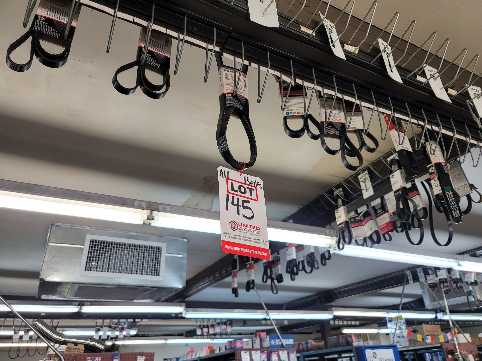 LOT - APPROX. (252) VARIOUS V-BELTS & SERPENTINE BELTS HANGING THROUGHOUT THE STORE, TAKE AS MANY OF