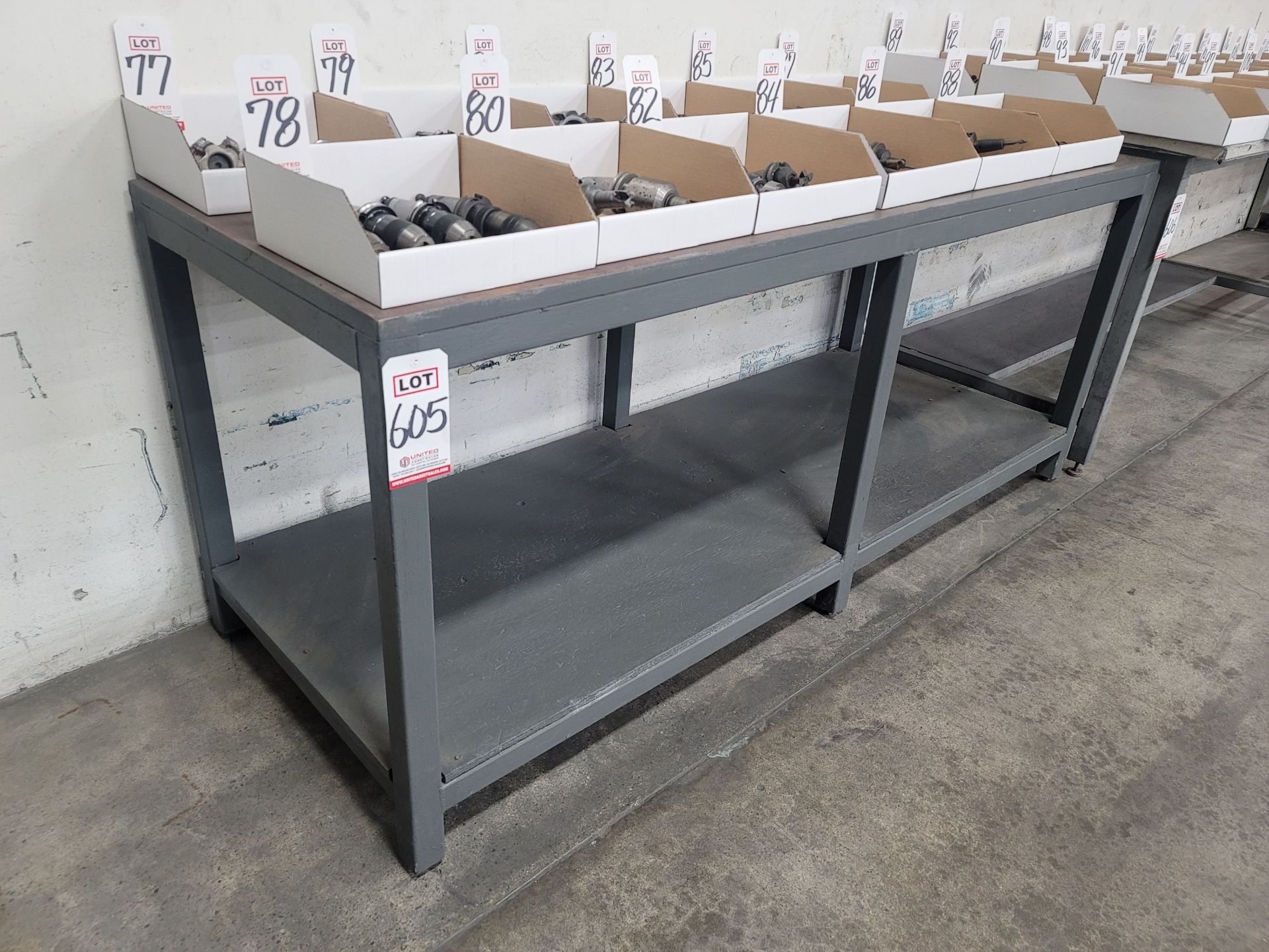 STEEL TABLE W/ 82" X 30" X 1" THICK STEEL TOP, PLYWOOD BOTTOM SHELF, 34" TOP HEIGHT, CONTENTS NOT