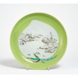 LARGE LANDSCAPE DISH. China. Qing dynasty. 19th c. Heavy porcelain with monochrome apple green