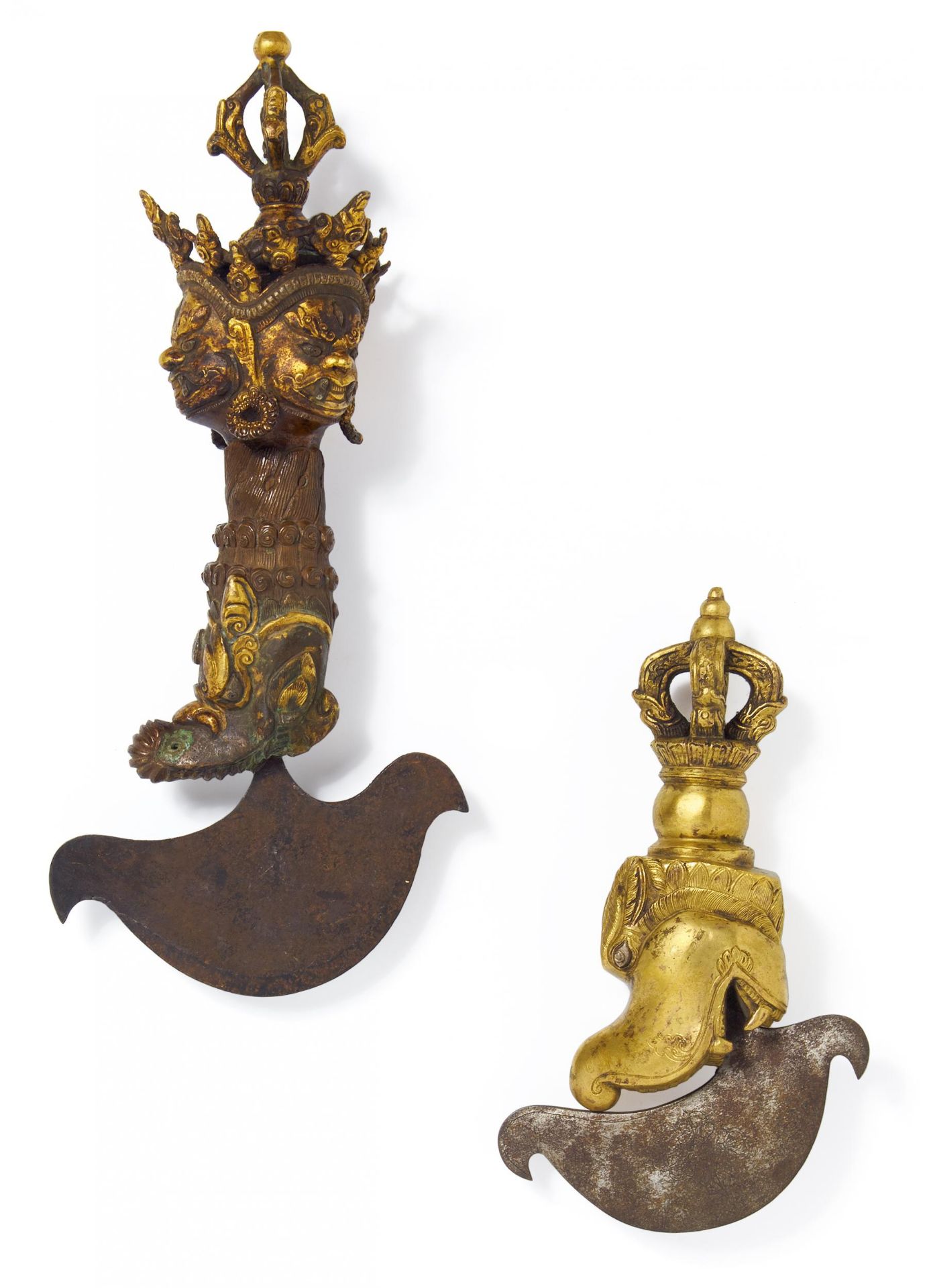 TWO KATRIKI KNIVES WITH MAKARA, THREE FACES AND VAJRA. Tibet/Nepal. 19th/20th c. Copper bronze,