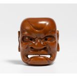 NETSUKE: LARGE BUAKU MASK. Japan. 19th c. Boxwood, carved. H.6.2cm. Condition A/B.Special Conditions