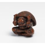 NETSUKE OF A SETSUBIN ONI AT NEW YEAR. Japan. 19th c. Box wood, carved and polished, beans partly