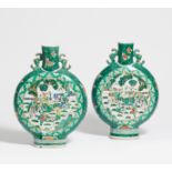 A PAIR OF MOON FLASKS WITH SCHOLARS. China. Before 1900. Heavy porcelain painted in famille verte.